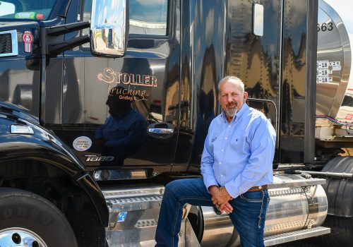 Brian Stoller standing next to a Stoller truck