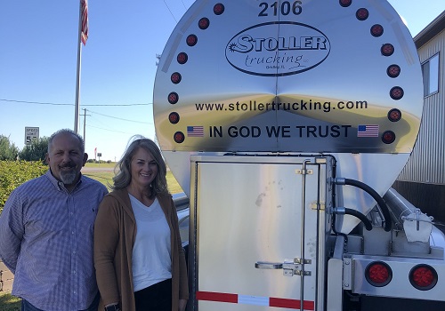 The owners of Stoller Trucking standing outside of a Bulk Transport going to Madison WI