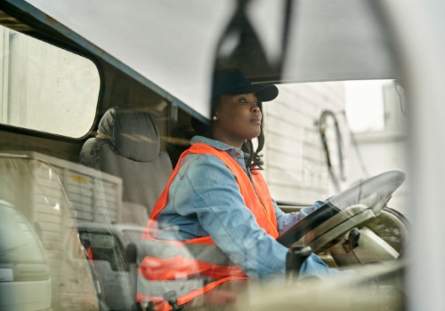 A driver in her truck cab, performing Truck Driver Jobs in Illinois