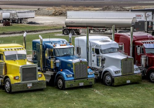 Colorful trucks lined up in front of Stoller Trucking