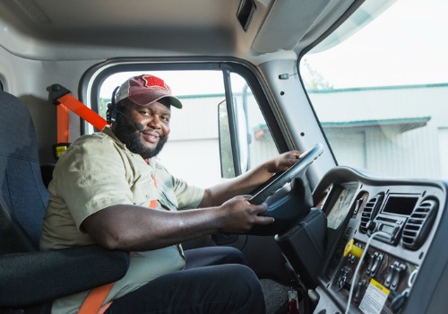 Happy truck driver in red hat on Truck Driver Jobs in Michigan