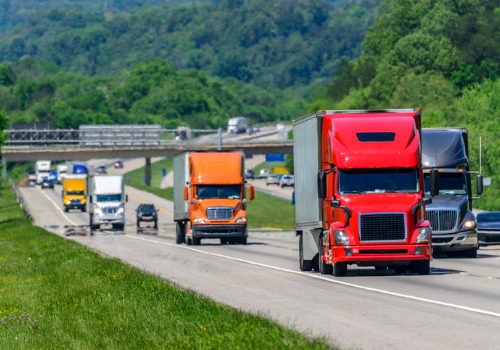 Lots of trucks driving down highway, working for Trucking Companies in Des Moines IA