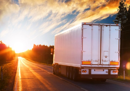 A truck on the road, heading towards a sunrise, working truck driving jobs in Michigan