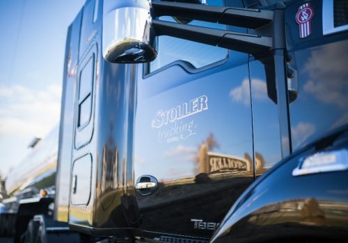 Shiny black truck outside of Stoller Trucking
