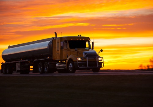A bulk transport driving along the sunset while making deliveries in the Midwest