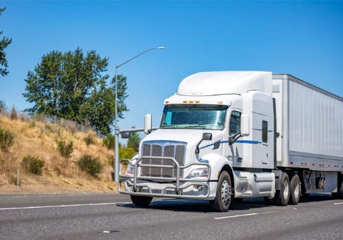 A white truck on the road, making a delivery for General Freight Trucking in Rockford IL