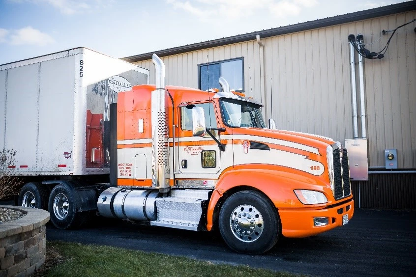An orange Stoller truck ready for Freight Shipping in Ohio