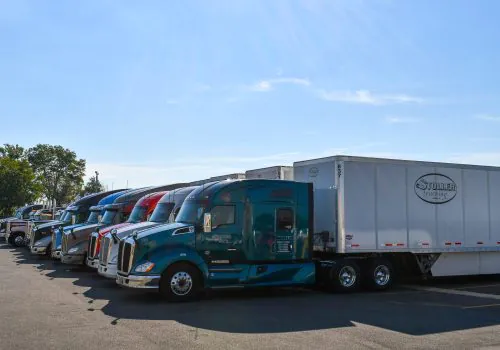 A row of Stoller trucks ready for Bulk Transport to Des Moines IA