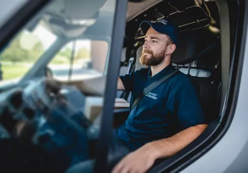 Happy truck driver representing the company driver team at Stoller Trucking., one of many careers offered by Stoller.